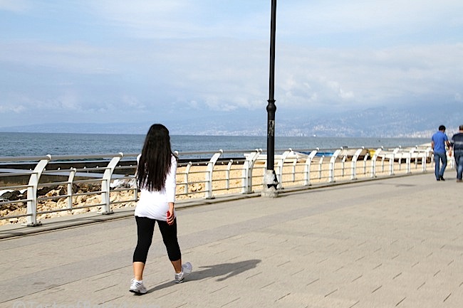 girl walks Corniche